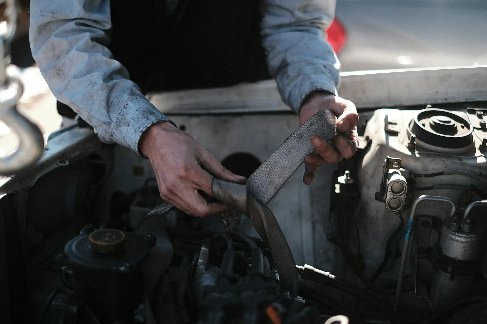 A mechanic working carefully on an engine bay
